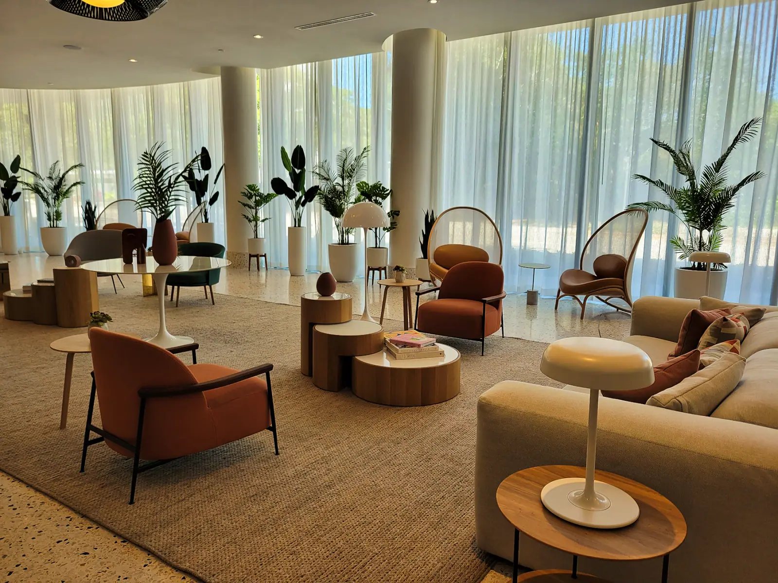 Contemporary hospitality lobby with curved seating and natural light